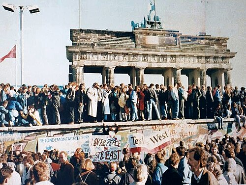 East and West Germans gathered at the Berlin Wall by the Brandenburg Gate in 1989.